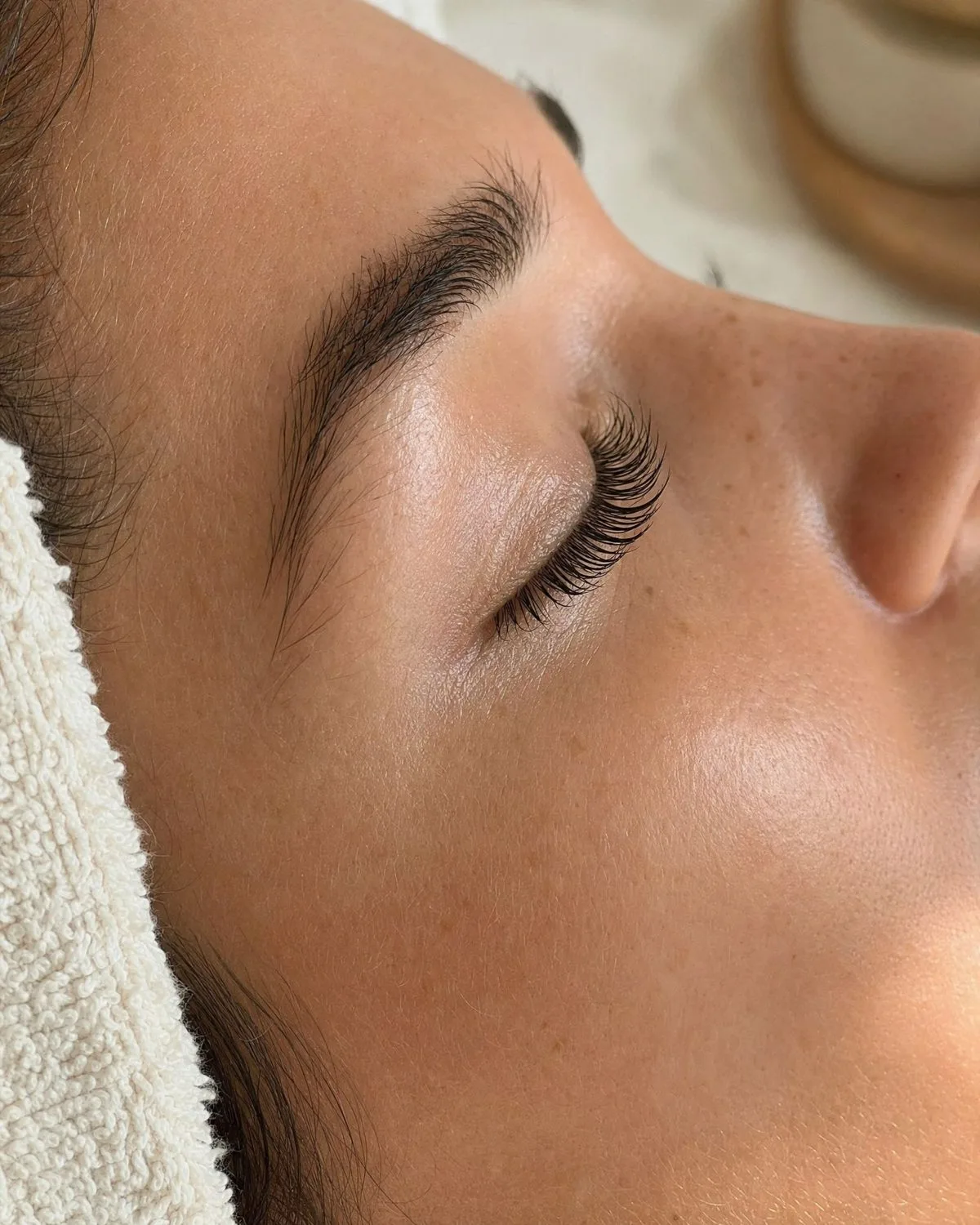 Closed eye with lifted, tinted lashes after a lash lift